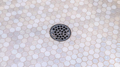How to Clean a Shower Drain of Cement Quickly